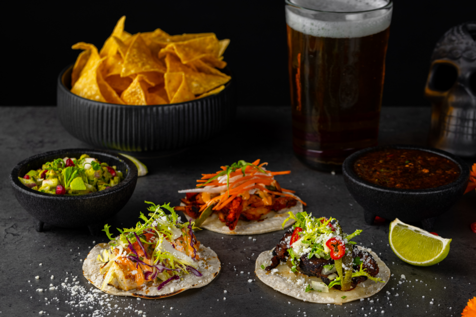 Taco trio with chips, dip, and beer